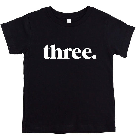 Black toddler shirt with minimalist "Three." text design for 3rd birthday