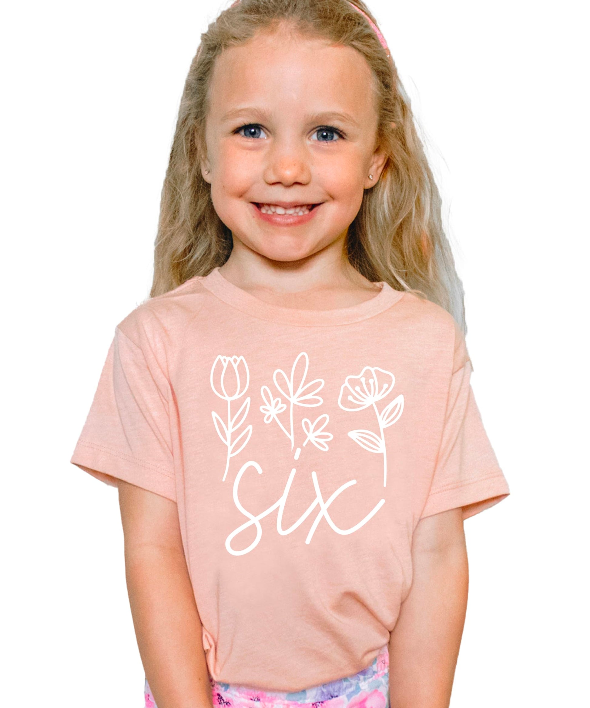 Side angle view of mauve floral sixth birthday shirt for toddler girls