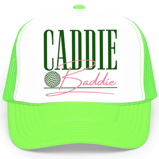 Close-up of Caddie Baddie hat design showing bold green CADDIE text with pink script Baddie and golf ball graphic