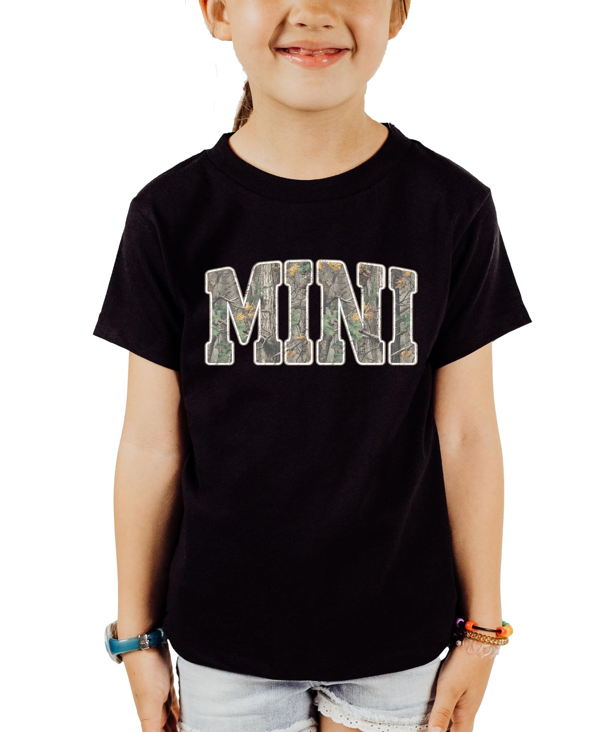 Close-up of mama shirt showing camo print MAMA text design on black fabric