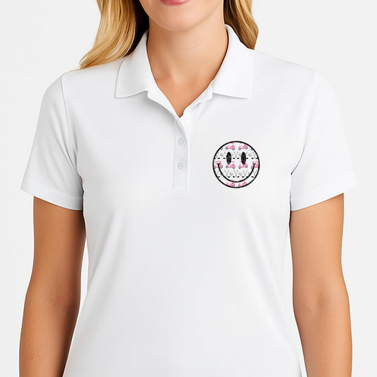 Side view of sleeveless golf polo shirt with pink golf themed graphics