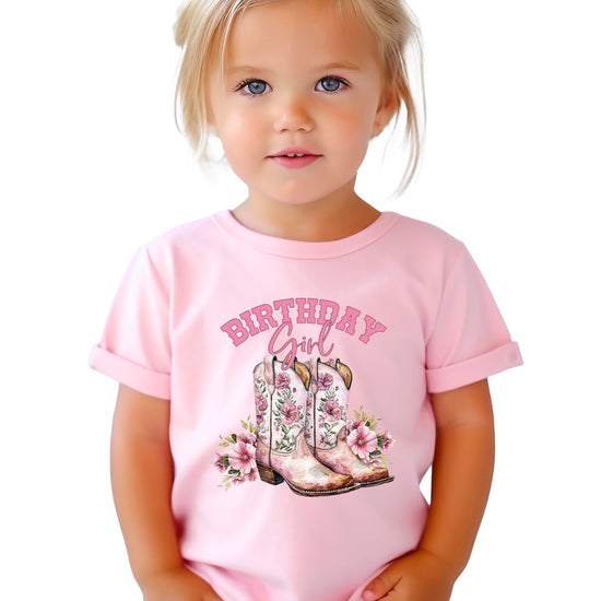 Close-up of pink cowgirl boots with floral details and birthday girl text graphic design