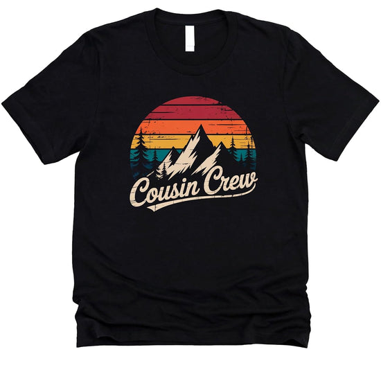 Close-up of Cousin Crew mountain graphic showing sunset gradient and pine tree silhouettes