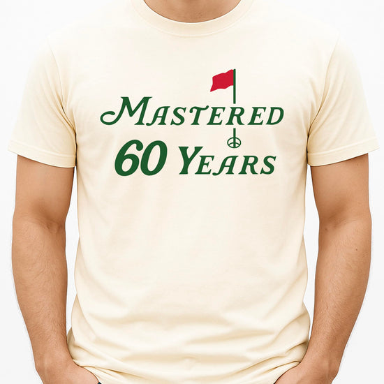 Mastered 60 Years golf shirt laid flat showing full front design and fit
