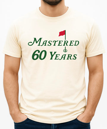 Mastered 60 Years golf shirt laid flat showing full front design and fit
