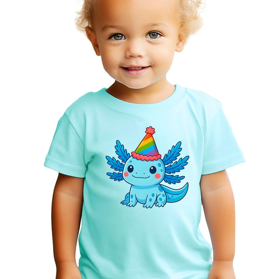 Kids birthday shirt with smiling blue axolotl wearing rainbow party hat on pink background