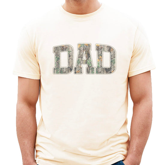 Product detail shot of camo DAD text on black men's graphic tee