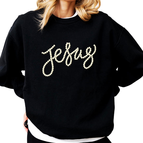 Close-up of pearl-style Jesus script text on army green crewneck sweatshirt