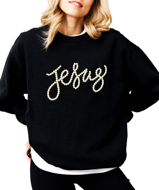 Close-up of pearl-style Jesus script text on army green crewneck sweatshirt