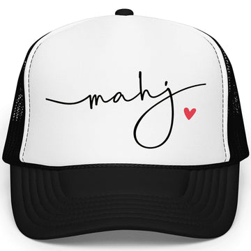 White mahj trucker hat with red heart detail worn by woman with blonde hair