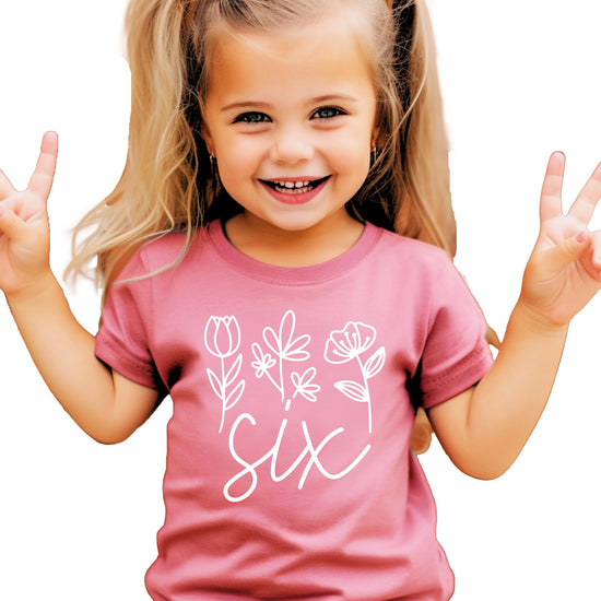 Full front view of toddler girl's 6th birthday shirt with floral number Six design
