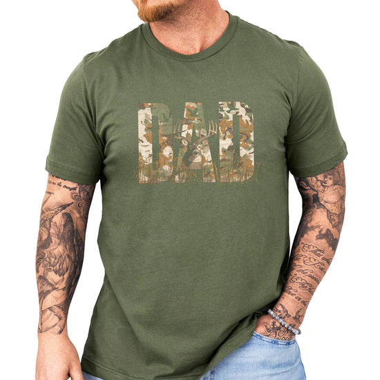 Product mockup of camo DAD deer hunting graphic tee on black shirt background