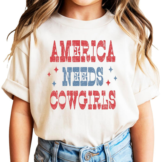 America Needs Cowgirls pink graphic tee with vintage western patriotic design