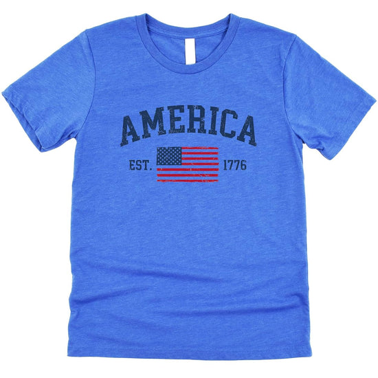 Close-up of weathered American flag graphic with vintage distressed design on patriotic t-shirt