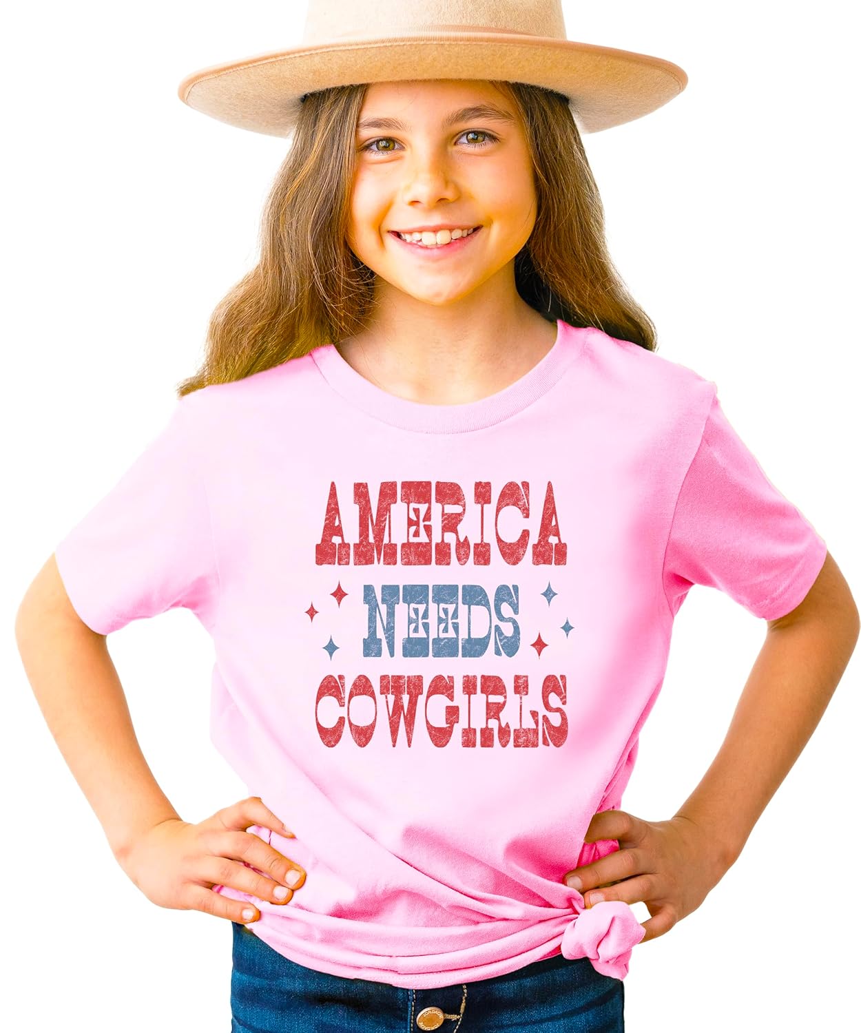 Close-up of America Needs Cowgirls vintage patriotic graphic design on pink tee