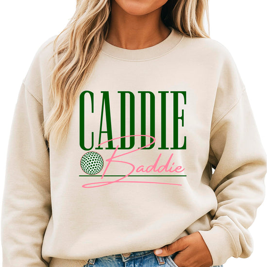 Woman wearing army green Caddie Baddie golf sweatshirt, front view