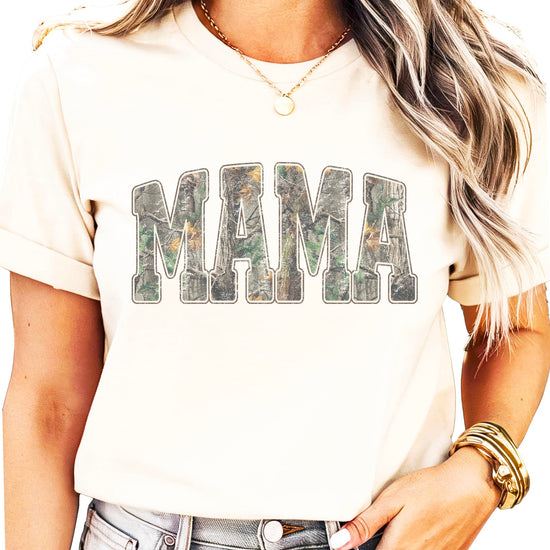 Flat lay of both mama and mini camo shirts arranged together showing matching design