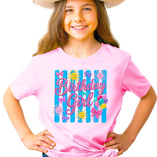 Close-up of Birthday Girl shirt showing colorful painted graphic with faux glitter script and balloon details