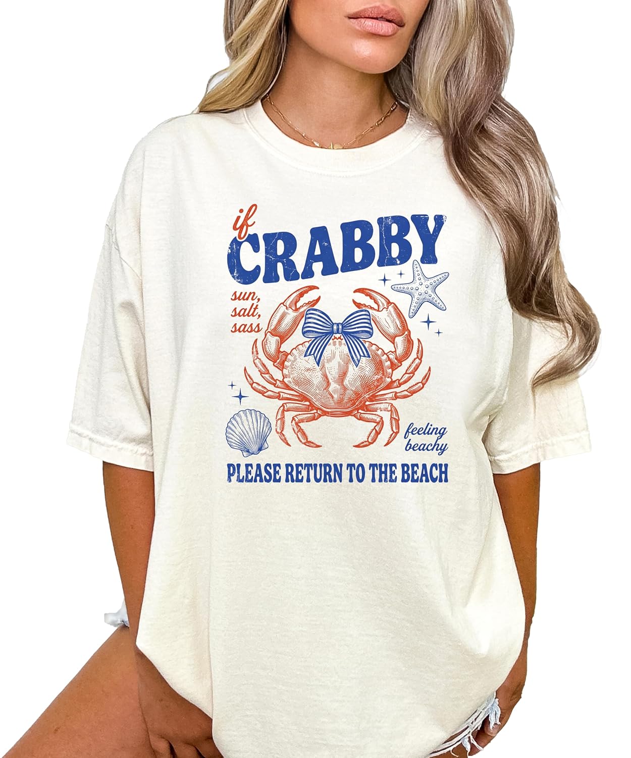 Woman wearing ivory crab graphic tee with coastal beach design and coquette bow