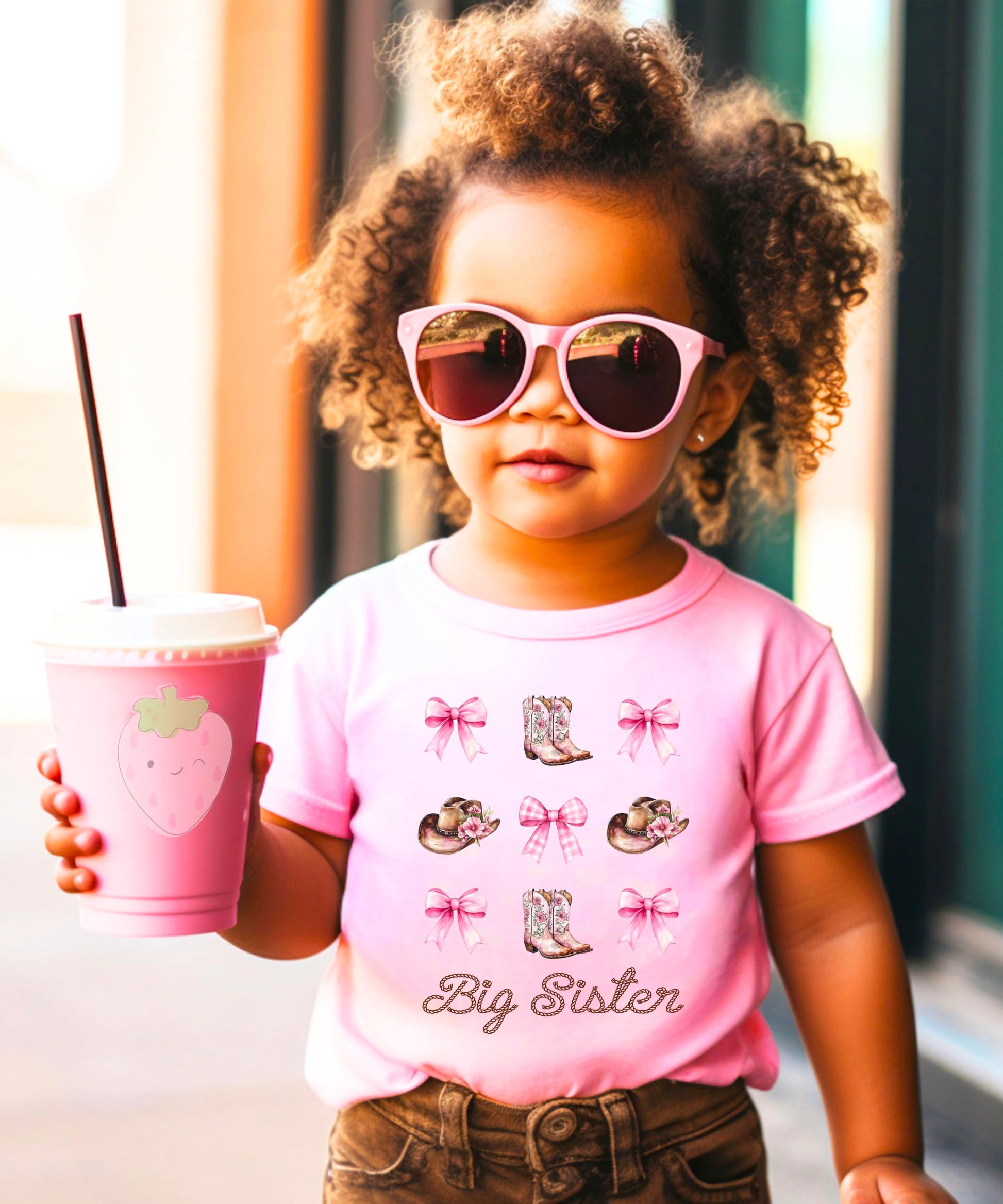 Full view of big sister cowgirl announcement shirt with western boots and bows design