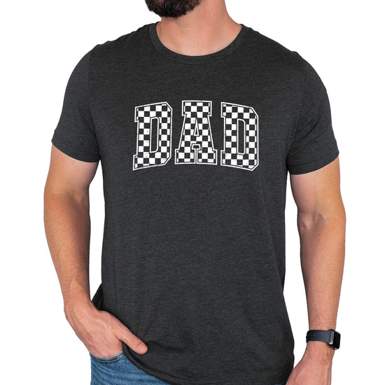 Close-up view of checkered DAD text graphic print on black men's t-shirt