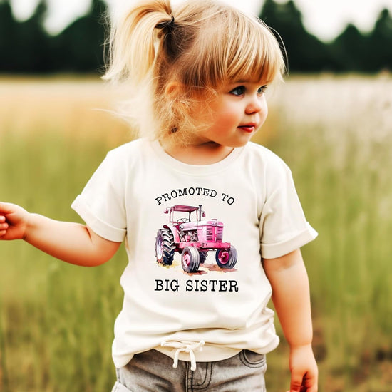 Big sister pink tractor shirt flat lay showing design details