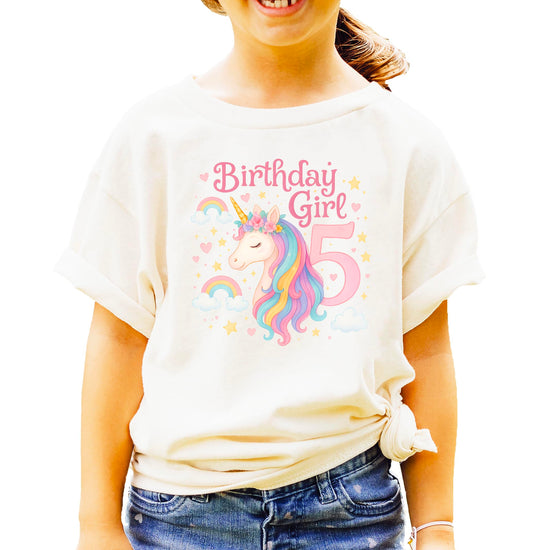 Fifth birthday unicorn tee displayed flat showing colorful magical design with hearts and stars
