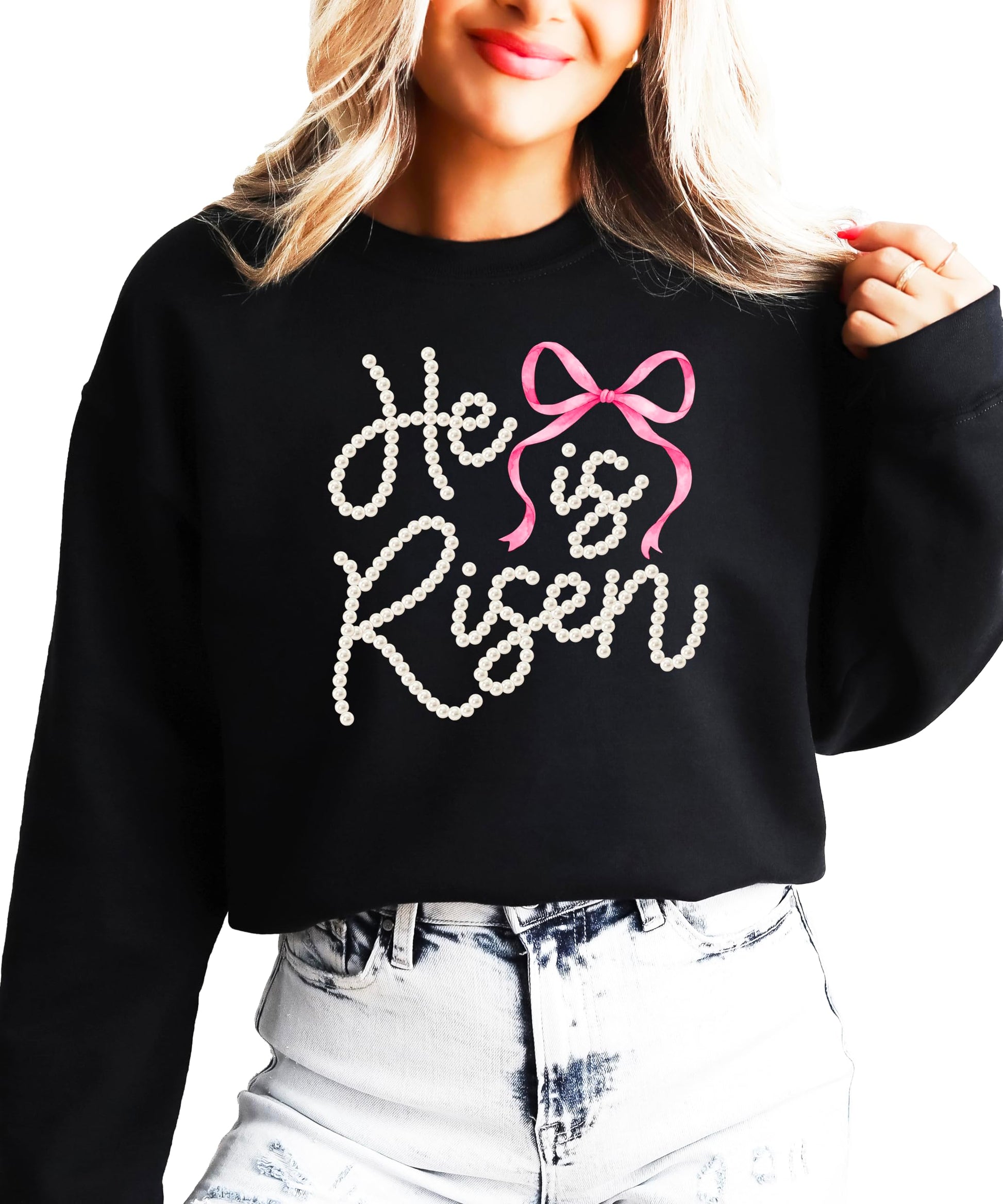 Close-up view of pearl He Is Risen text with decorative bow on green pullover sweatshirt