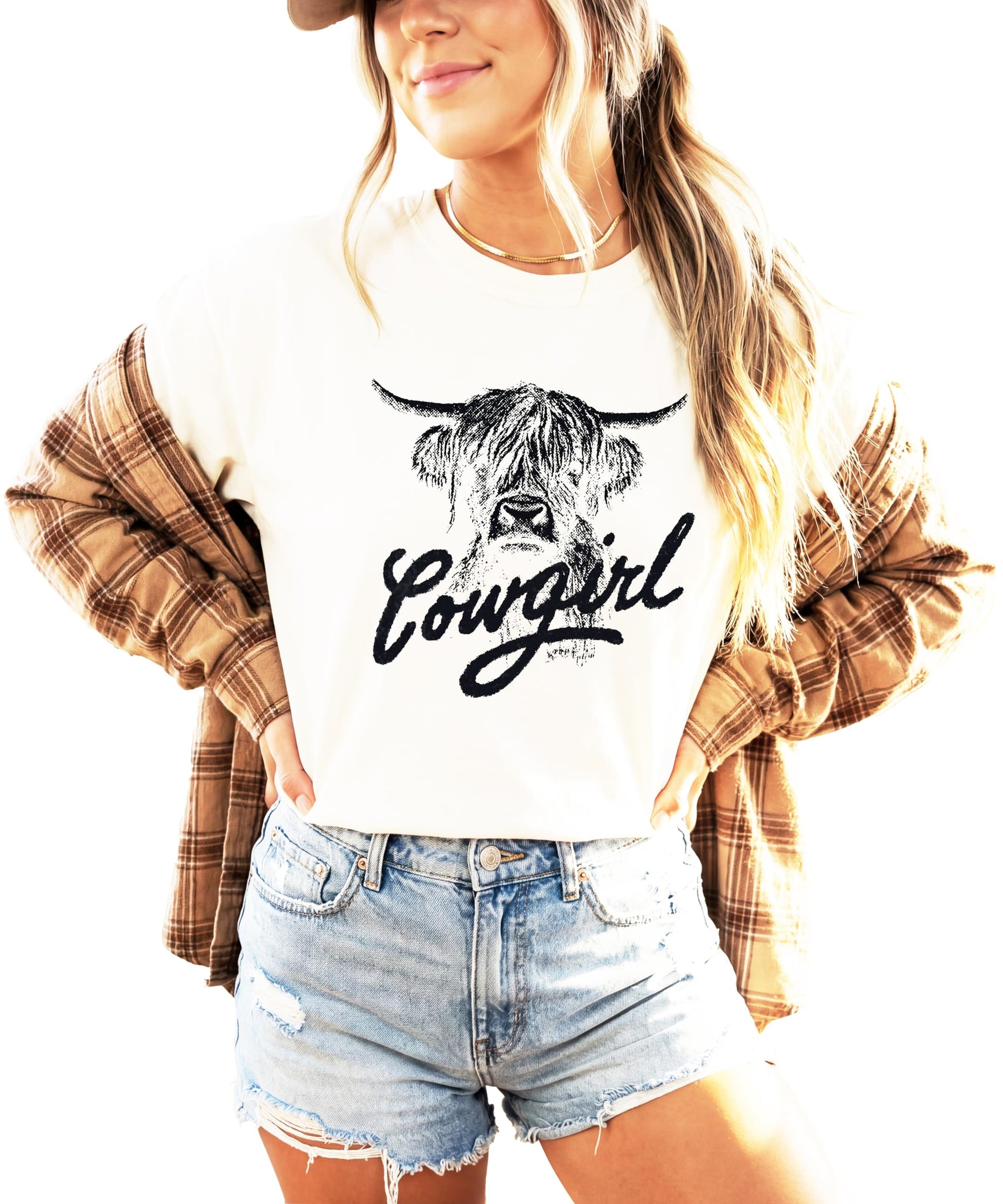 Close-up detail of highland cow design with cowgirl script on blue shirt