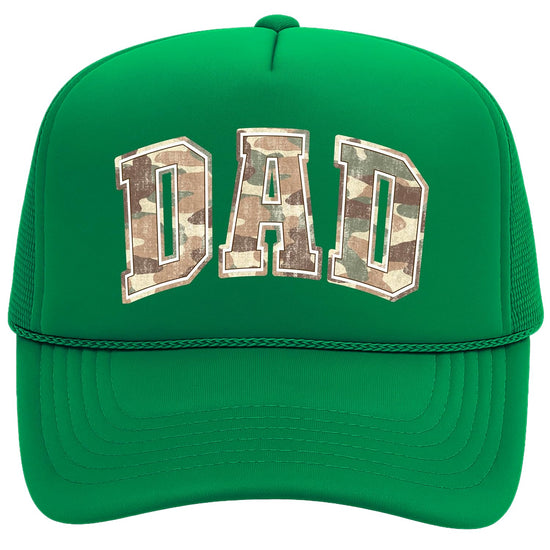 Close-up of camo DAD trucker hat showing distressed varsity lettering and mesh back panels