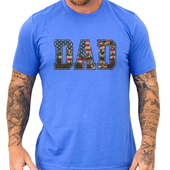 Natural colored patriotic dad t-shirt with DAD lettering filled with American flag and mountain camo design