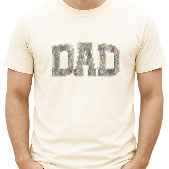 Close-up view of camouflage DAD lettering on black men's t-shirt