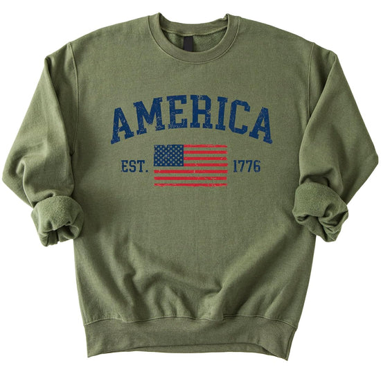America Est 1776 white sweatshirt with vintage distressed USA flag graphic and varsity lettering