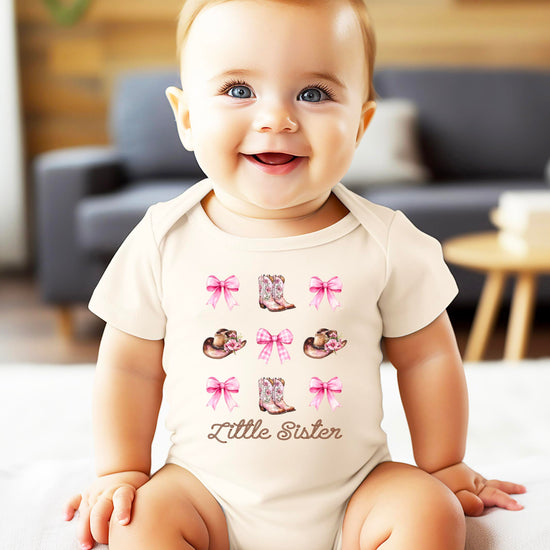 Detail shot of Little Sister bodysuit print quality and vibrant pink western design