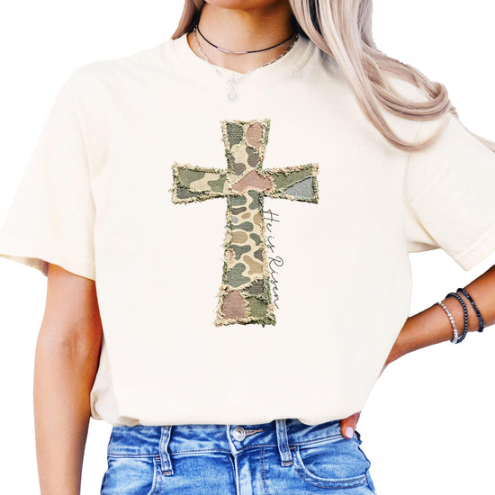 Detail shot of ink-printed He Is Risen text and cross graphic on blue fabric