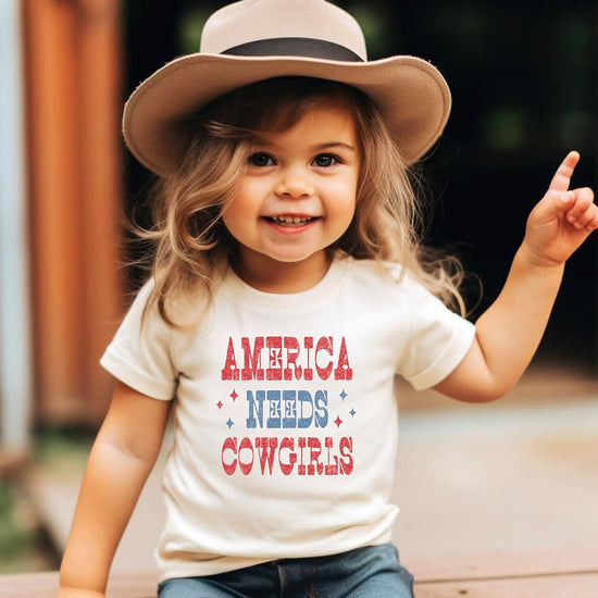 Back view of America Needs Cowgirls graphic tee showing shirt fit and style