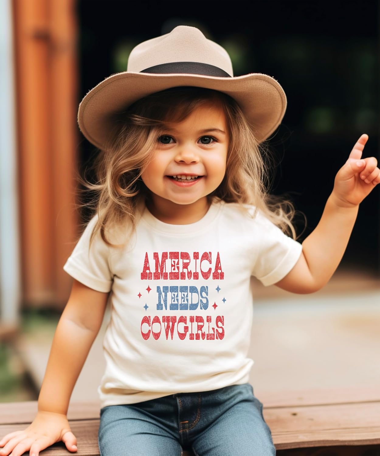 Back view of America Needs Cowgirls graphic tee showing shirt fit and style
