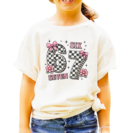 Six Seven birthday shirt with pink bows and checkered numbers on natural tee