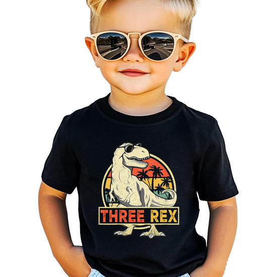 Side view of child in Three Rex birthday dinosaur t-shirt
