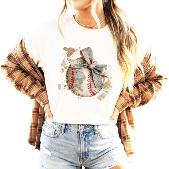 Women's baseball mom shirt laid flat showing full design with camo bow and baseball elements