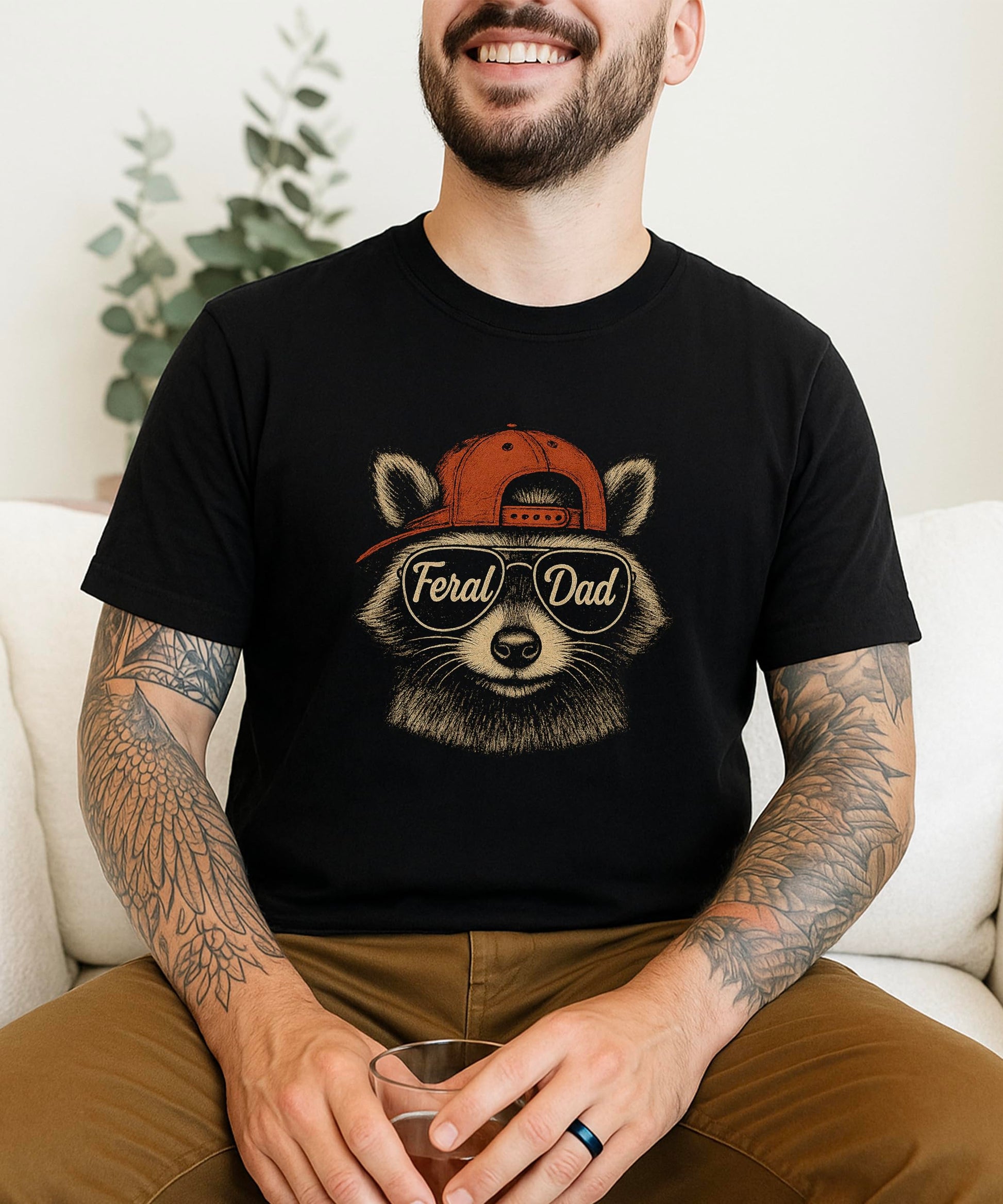 Man wearing Feral Dad raccoon graphic tee shirt showing fit and style