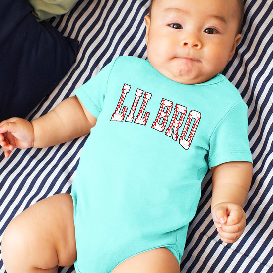 Detail shot of baseball stitching design elements on Lil Bro toddler bodysuit