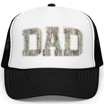 Close-up of woodland camouflage Dad lettering with white outline on trucker hat