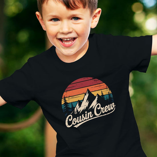Family wearing matching black Cousin Crew mountain shirts in various sizes