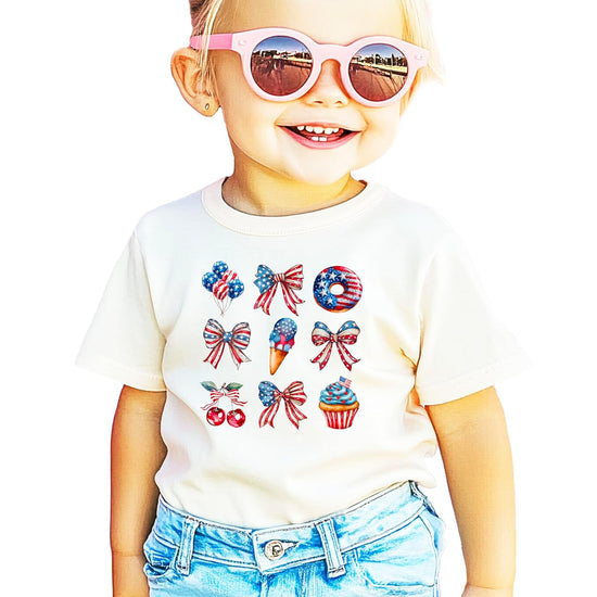 Pink patriotic shirt with red white blue bows cherries ice cream balloons cupcakes and donuts 4th of July design