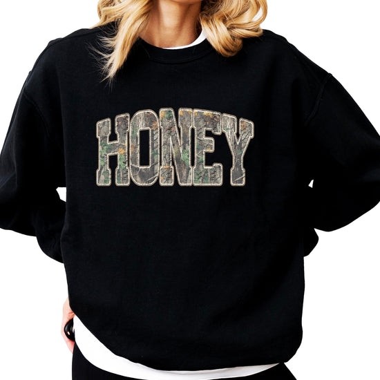 Woman wearing Honey Camo camouflage sweatshirt casual styling
