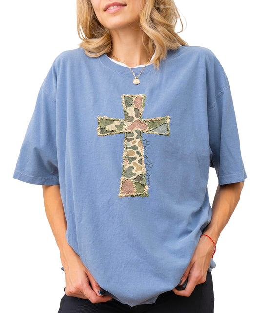 Women's blue He Is Risen cross graphic t-shirt with patchwork design on white background