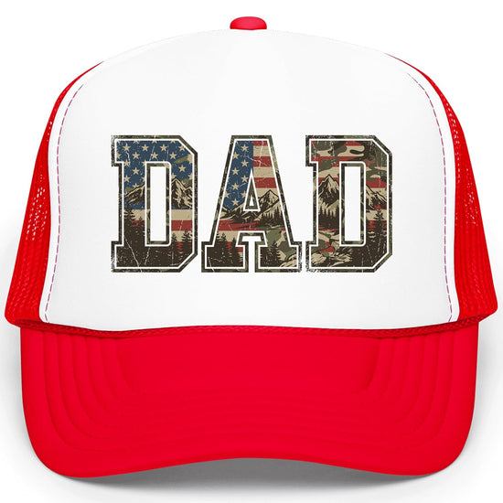 Close-up of DAD lettering filled with stars and stripes blending into camo mountain scene on trucker hat