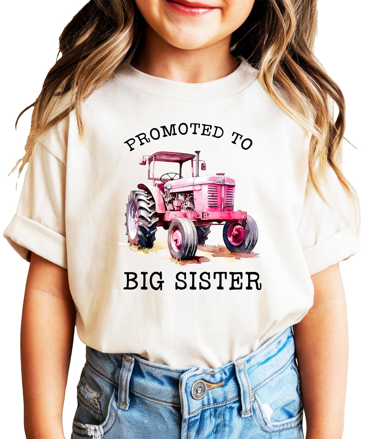 Pink promoted to big sister tractor shirt on young girl outdoors