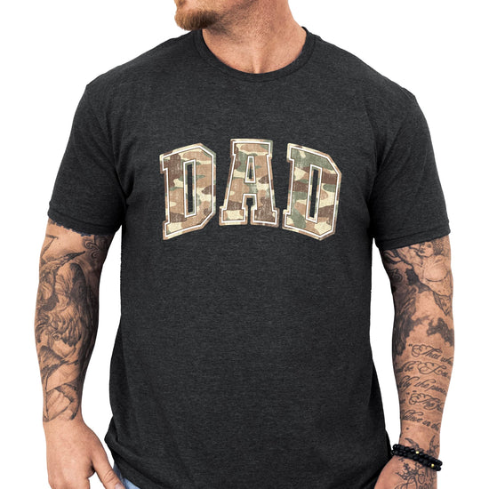 Close-up view of camo DAD text graphic print on black shirt